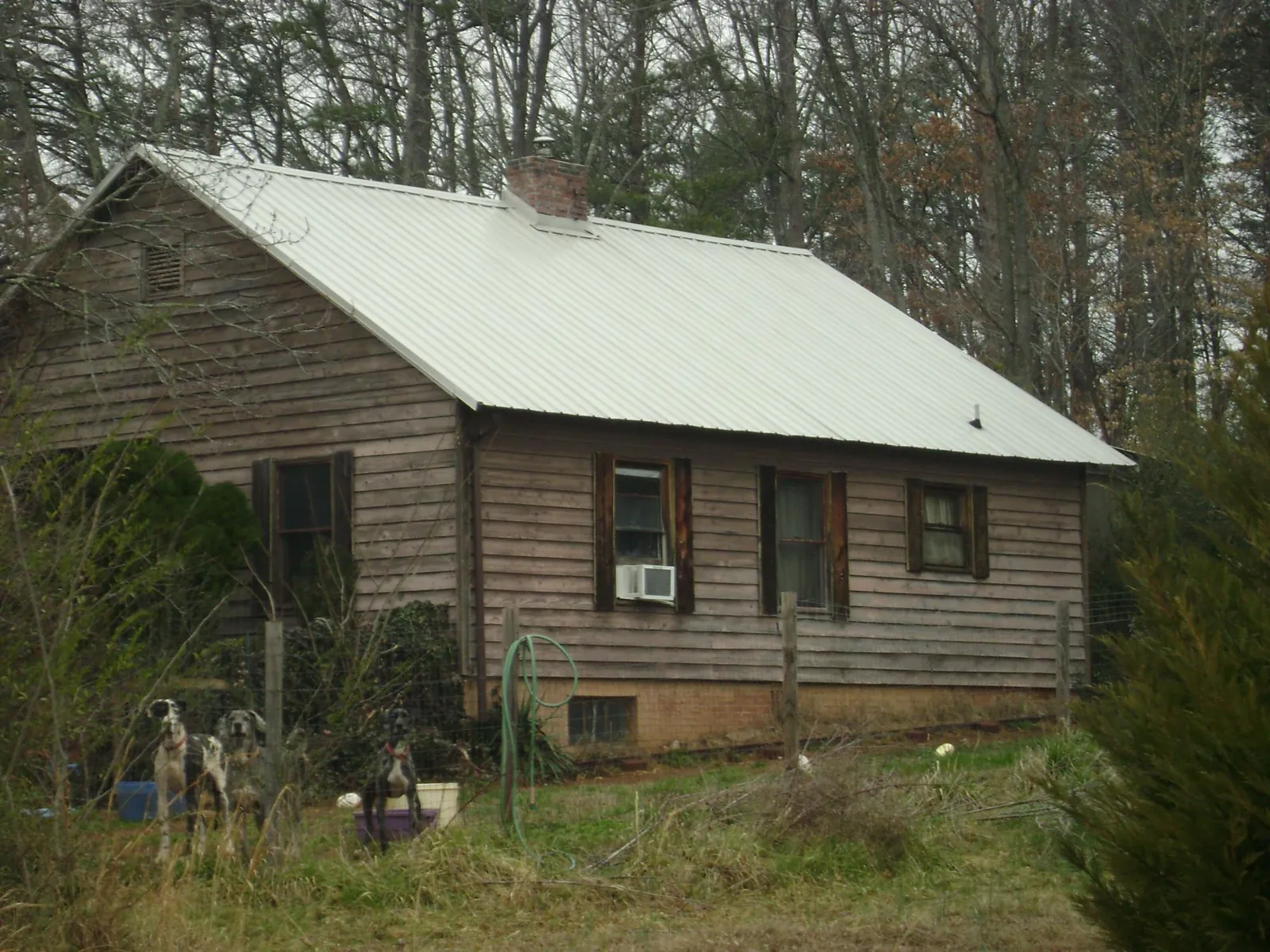 White metal roof on an old wood sided farmhouse, from a Asphalt Shingle Roof Repair job in Oxford